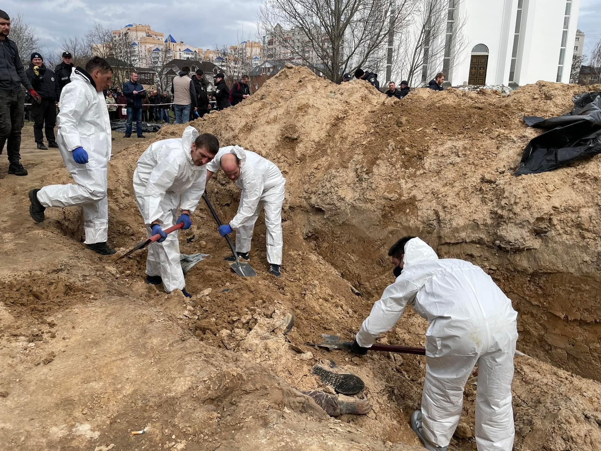 Массовое убийство мирных жителей в Буче: криминалисты начали эксгумацию тел с братской могилы (ФОТО) - фото 3